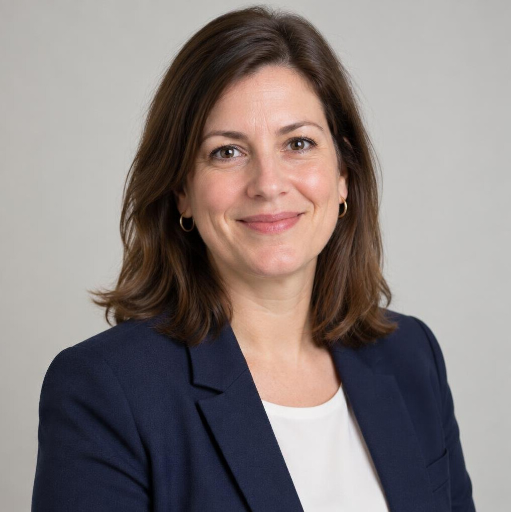 Professional woman with dark hair smiling in office